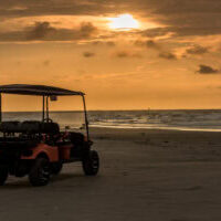 Golf cart parked on beach near sunset in Port Aransas, Texas Golf cart parked on beach near sunset in Port Aransas, Texas